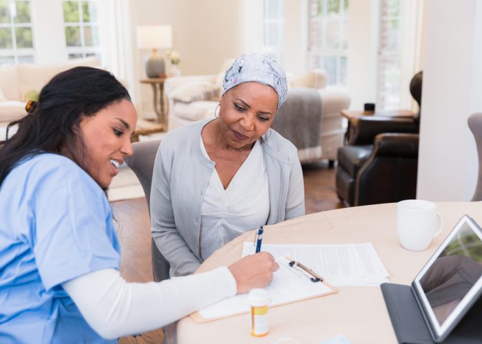 Nurse talks to patient at long term care home