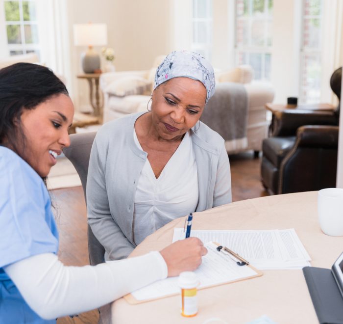 Nurse talks to patient at long term care home